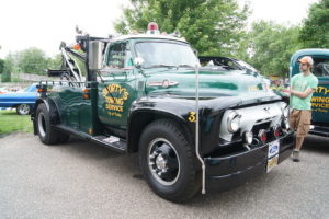 towing company truck that is a classic and green color